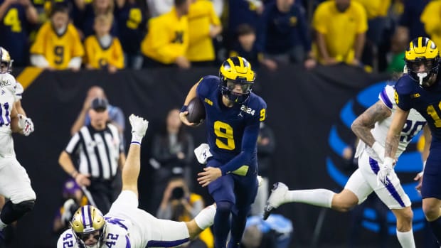 Jan 8, 2024; Houston, TX, USA; Michigan Wolverines quarterback J.J. McCarthy (9) runs with the ball against Washington Huskies linebacker Carson Bruener (42) during the third quarter in the 2024 College Football Playoff national championship game at NRG Stadium.